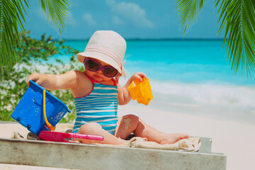 Wall Mural - cute happy girl play with sand on beach