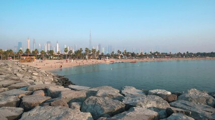 Wall Mural - Dubai, United Arab Emirates - May 18, 2021: La mer beach and Dubai downtown skyline from rising above the seaside