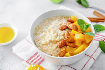 Wall Mural - Breakfast oatmeal with peaches, cinnamon and almonds