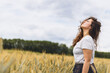 © ANASTASIA - Young carefree woman in rustic dress Breathing Deep Fresh Air In A grassy Field. Space for text. walking in summer meadow. Atmospheric authentic moment. Rural slow life