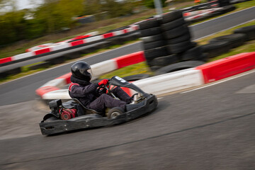 Wall Mural - A panning shot of a racing kart as it circuits a track.