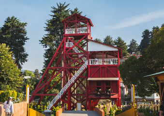 Ancient mining structure in the shape of a tower with its characteristic red color, now used as a tourist place in the Magical Town of El Oro, State of Mexico.