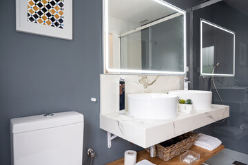 Interior of light modern bathroom with a mirror with light