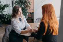 Empathy, Friendly Support, Each Other's Support And Sisterhood. Young Woman Comforting Her Friend Sitting In Cafe. Female Psychotherapist Supporting Her Depressed Patient.