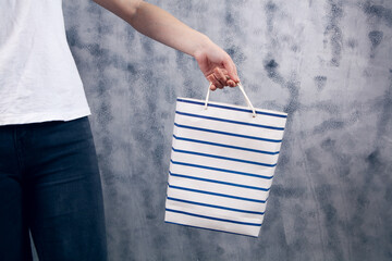 Wall Mural - young woman holding a gift bag