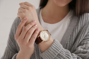 Sticker - Woman with luxury wristwatch on light background, closeup