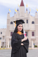 Wall Mural - Female graduates happily celebrate university graduation with diploma