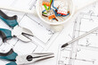 © ratmaner - Tools using for works, electric box with connected cables and diagrams of plan with electrical installation. Building home