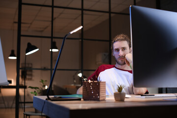 Canvas Print - Handsome man working at home late in evening