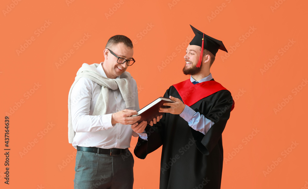 Happy male graduation student with his father on color background