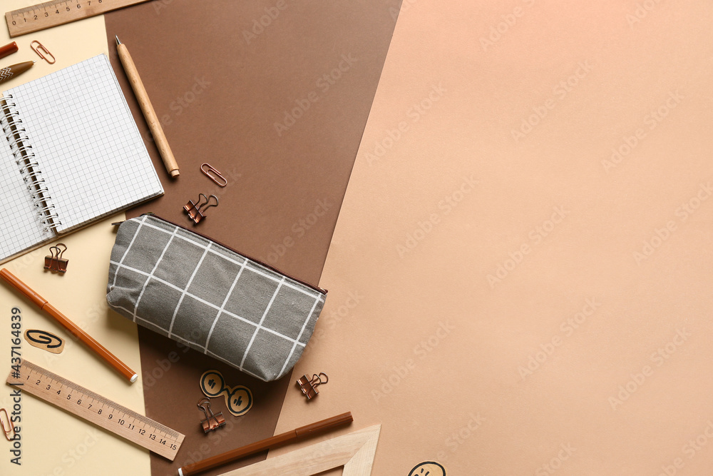 Pencil case with stationery on color background
