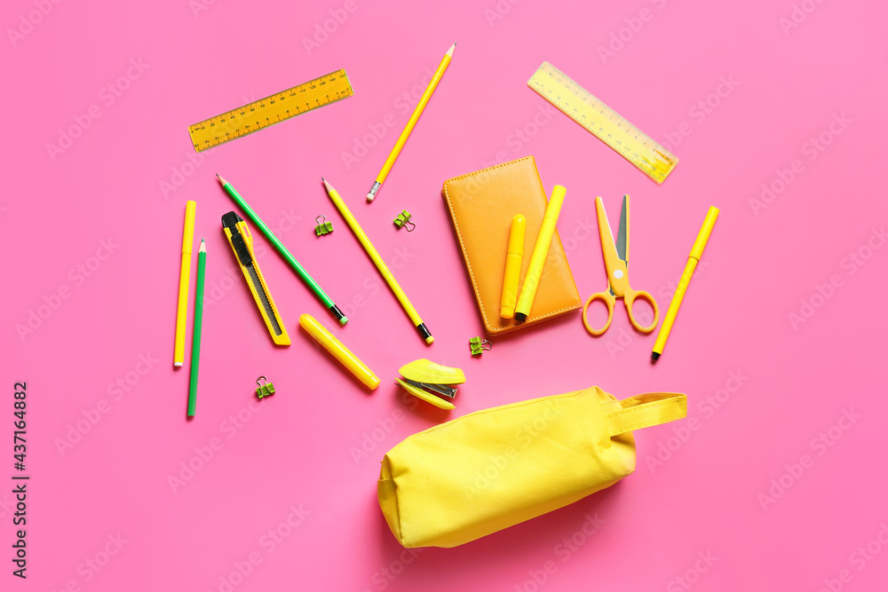 Pencil case with stationery on color background