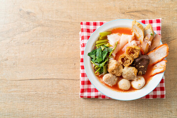 noodles with meatballs in pink soup