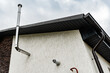 Central gas heating boiler flue chimney on house exterior.