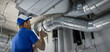 © ronstik - hvac worker install ducted pipe system for ventilation and air conditioning. copy space