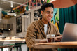 © Drobot Dean - Young hispanic man student sitting at the cafe table indoors