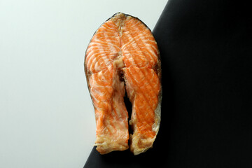 Tasty grilled salmon on two tone background