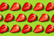 Slices Of Strawberries On A Green Background As A Summer Backdrop