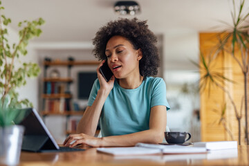 adult woman, making a phone call to her doctor, from home.