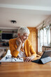 © bnenin - Senior woman, enjoying her break, at home office