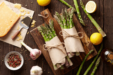 Fresh green asparagus with parmesan cheese on planks