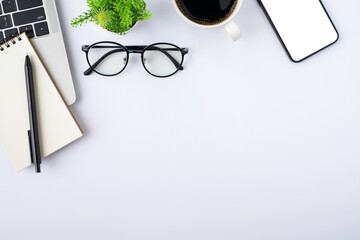 Wall Mural - Top view above of White office desk table with keyboard, notebook and coffee cup with equipment other office supplies. Business and finance concept. Workplace, Flat lay with blank copy space.