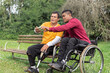 © Vergani Fotografia - person in wheelchair and friend looking at cell phone screen...