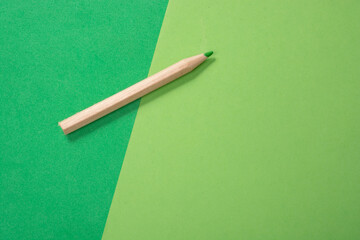 Sticker - Green pencil on a green paper texture