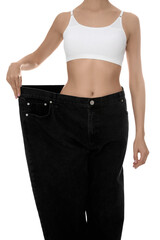 Canvas Print - Young woman wearing big jeans after weight loss on white background, closeup