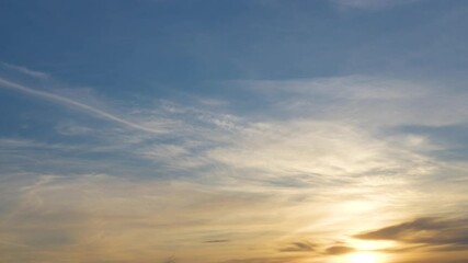 Wall Mural - 4k stock video footage of beautiful peaceful sunset blue sky with soft orange fluffy clouds