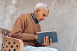 elderly person reading a book