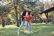 © gstockstudio - Happy father and son playing football and smiling while having fun on the backyard