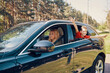 © gstockstudio - Young beautiful family with little boy having fun and smiling while driving in the car
