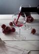 Two glasses of red wine on white wooden table. Still life composition with space for text.