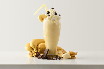 Wall Mural - Banana milkshake with choco decorated with fruit on table isolated