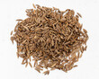top view of pile of caraway seeds close up on gray