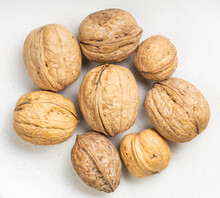 Several Whole Walnuts Close Up On Gray