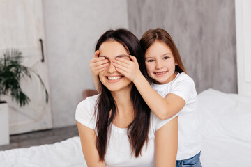  Mirthful girl having fun with her mother