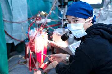 male perfusionist sitting in cardiac operating room