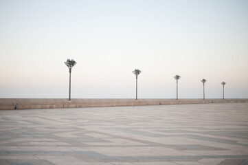 pavers ornament and street lights of vast expanses of squares Casablanca embankment Hassan II Mosque in sunset illumination