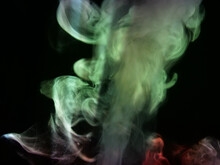 Abstract Colour Series. Composition Of Colourful Smoke In Motion. Fusion Of Green Mist Isolated On A Dark Background To Inspire Creativity.