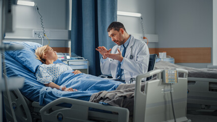 Wall Mural - Hospital Ward: Friendly Doctor Talks to Smiling Young Woman Resting in Bed, Fully Recovering after Sickness. Physician Uses Tablet Computer, Does Checkup, Gives Treatment Advice, Health Recommendation