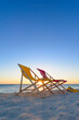 Beach chairs and fins on the shoreline at sunset, beautiful beach