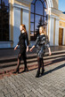 Luxury and elite lifestyles, Fashion week, style, glamor, fashion show, runway, catwalk. Candid portrait of two fashion model girls in sparkling cocktail dresses are walking on city street.