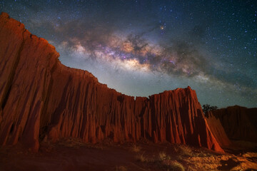 Wall Mural - Beautiful milky way raised over natural earth pillar in various shapes crafted by soil erosion in Lalu, Sakaeo, Thailand