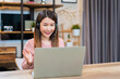 © structuresxx - Asian woman using laptop making video call for distant meeting or online support working from home while coronavirus pandemic