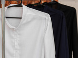 Fototapeta Sypialnia - Clothes hanger with assorted linen shirts