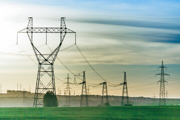 High voltage power line on industrial electricity line tower for electrification rural countryside