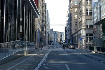 Unrecognisable person walking lonely in the empty streets