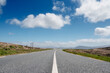 Narrow asphalt road on a warm sunny day, beautiful cloudy sky, nobody. Achill island, county Mayo, Ireland. Travel concept